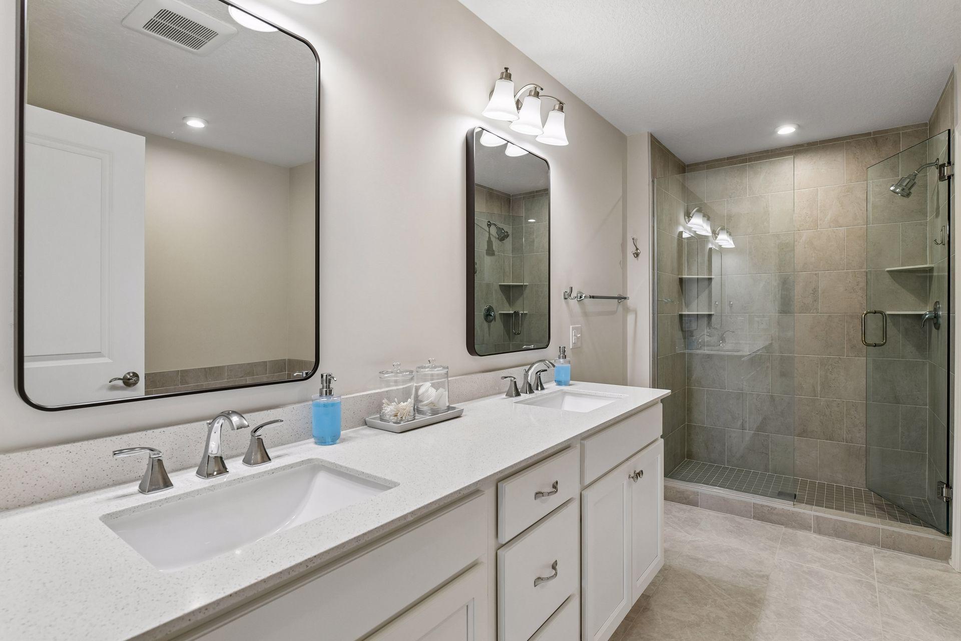 The Primary Bathroom offers a comfort-height vanity with quartz countertops, a large soaking tub and a tiled shower with glass enclosure.