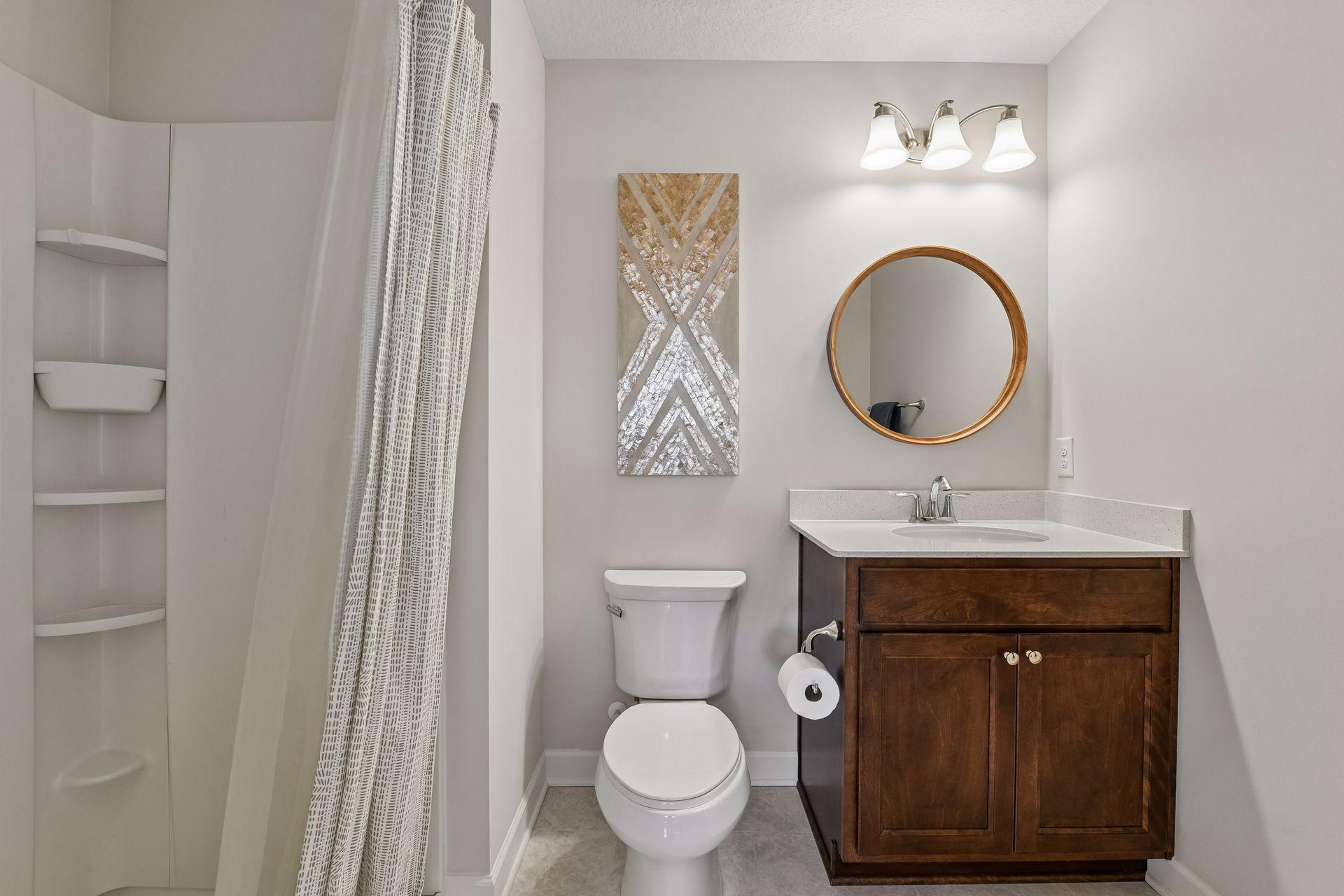 The 3/4 en suite bathroom offers a comfort-height vanity with quartz countertop.