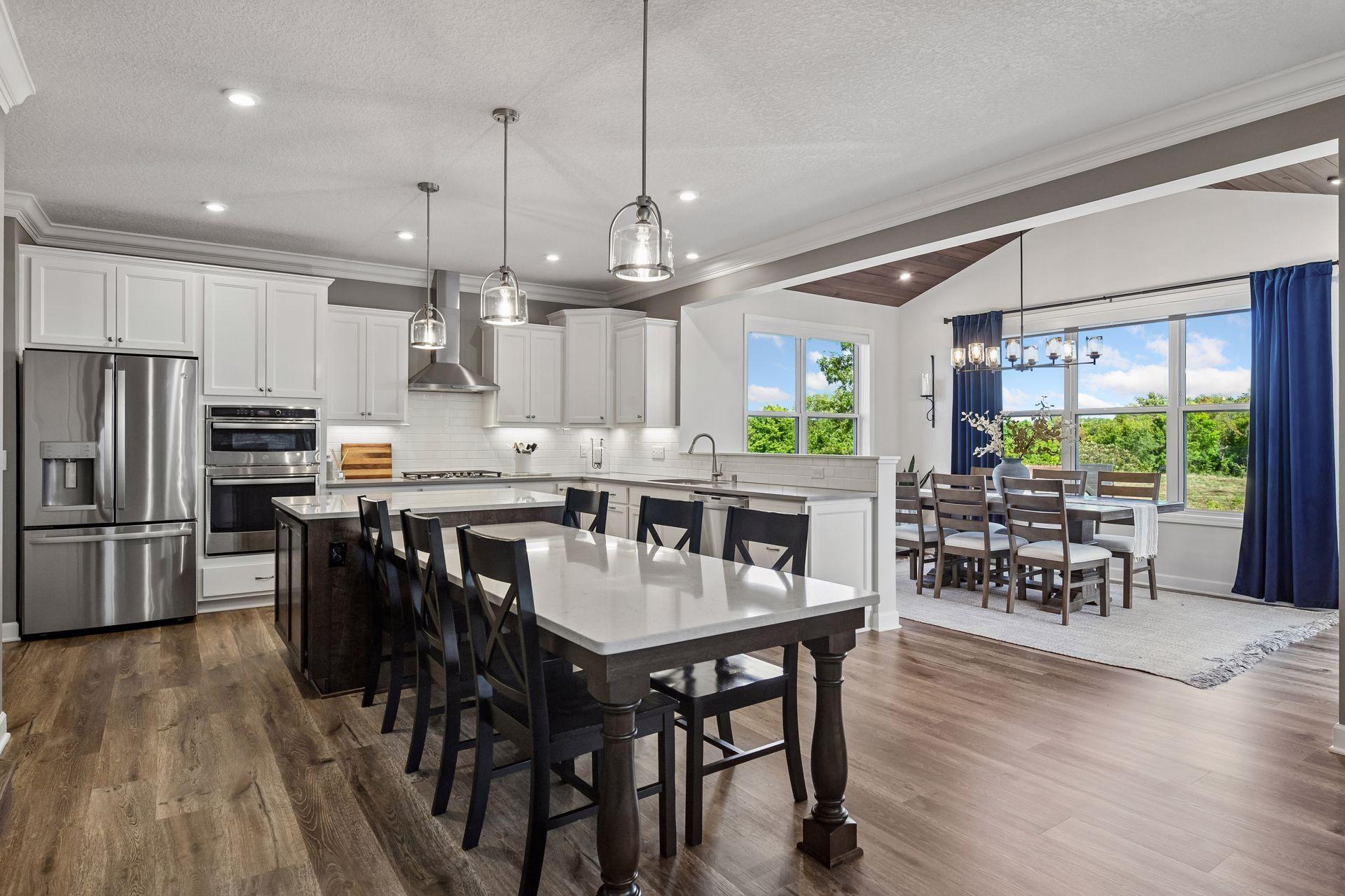 The upgraded Chef's Kitchen features custom cabinetry including the island and dining table.