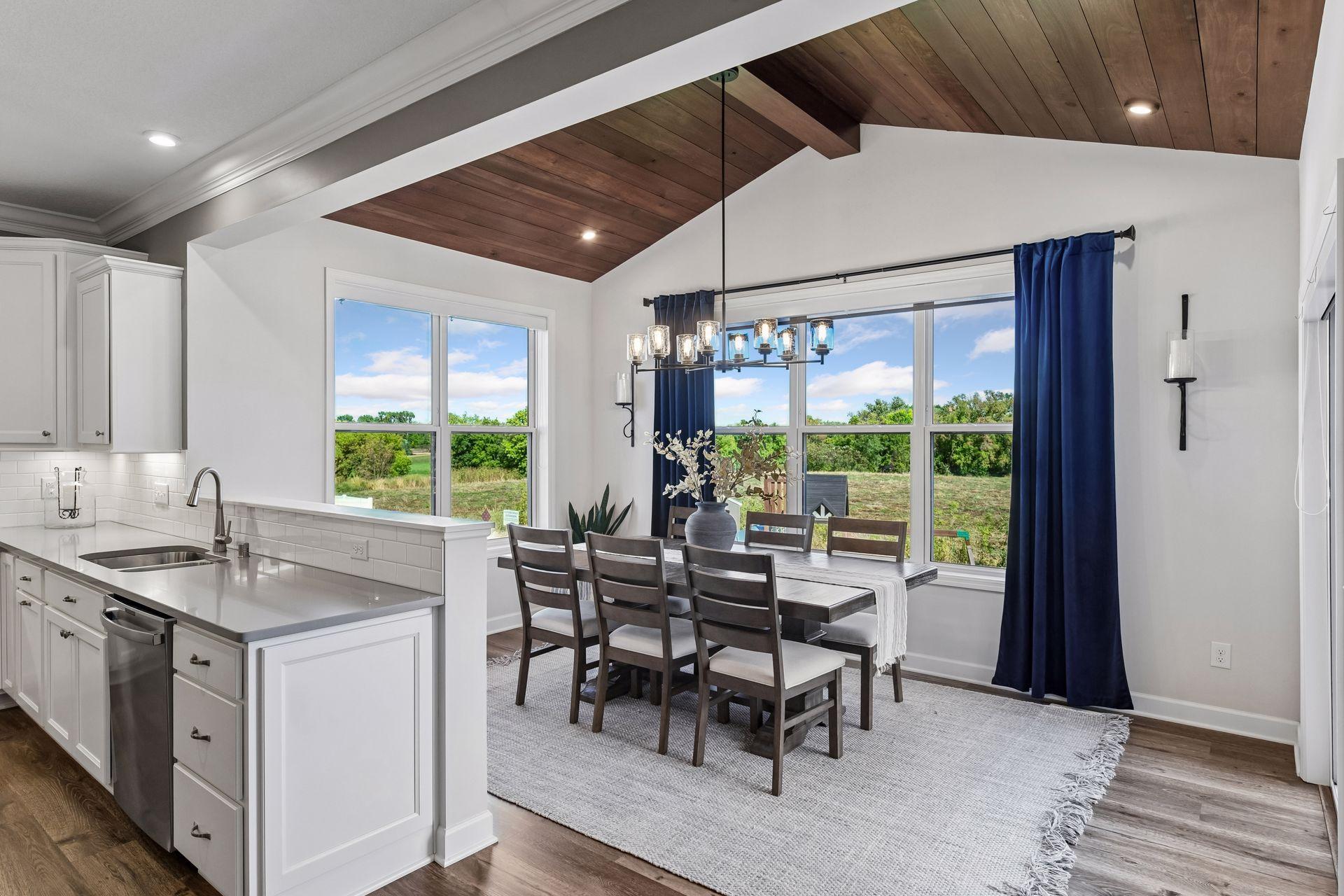 The vaulted Dining Room features a tongue-and-groove ceiling with designer lighting.