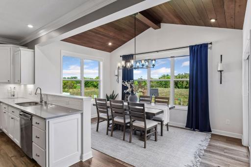 The vaulted Dining Room features a tongue-and-groove ceiling with designer lighting.