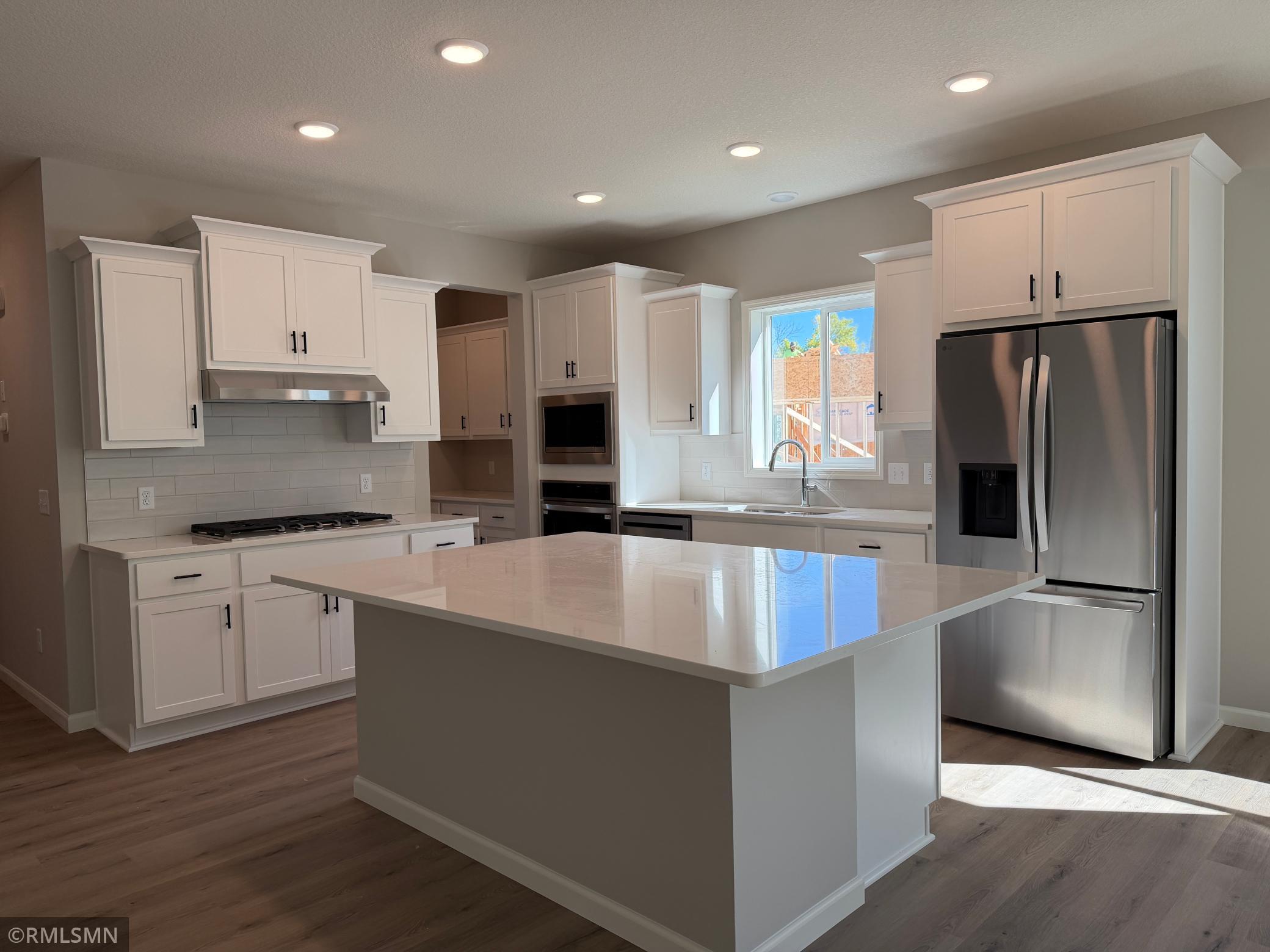 Kitchen with huge kitchen island and built in appliances