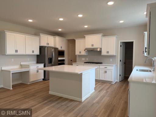 Kitchen with HUGE island, white quartz countertops and built-in appliances