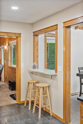 A convenient pass-through breakfast bar creates a casual spot for morning coffee or conversation with the cook.