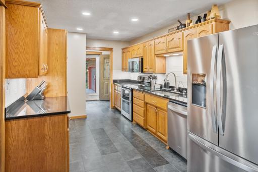 Updated kitchen offers abundant cabinetry, generous counter space and newer stainless steel appliances.
