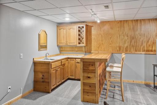 Built-in wet bar with seating makes entertaining downstairs easy.
