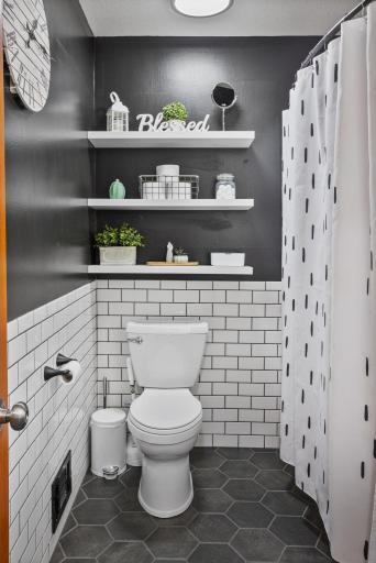 Floating shelves add both style and convenient storage in the updated bath.