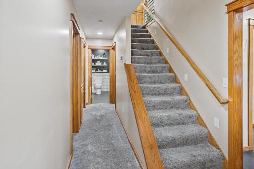 Main floor hall with stairs that lead up to the primary bedroom, loft and 4th bedroom.
