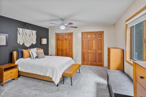 Spacious primary bedroom offers two closets, abundant natural light and plenty of room to unwind.