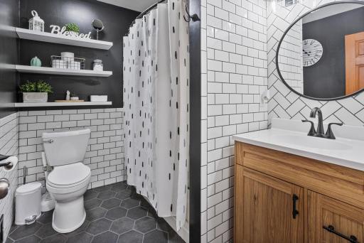 Completely updated full bath pairs bold style with classic white subway tile and modern finishes.