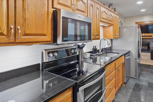 Newer stainless steel appliances pair beautifully with warm wood cabinetry and crisp white subway tile.