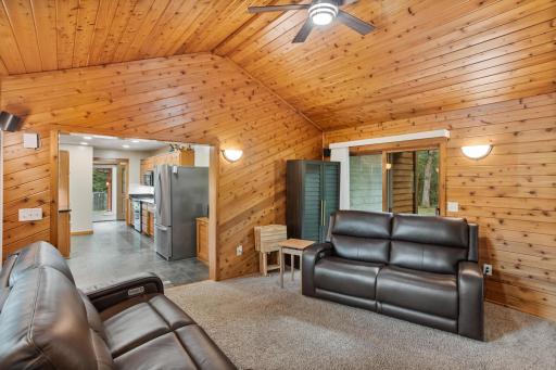 Warm wood walls and a vaulted ceiling give this inviting gathering space its unmistakable lodge-inspired character.