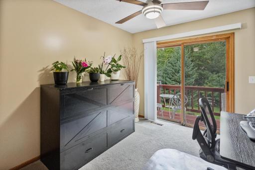 Comfortable bedroom with a sliding glass door leading directly to a private balcony.
