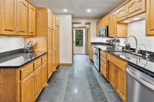 A spacious kitchen with extensive cabinetry, great counter space and easy flow into the surrounding living areas.