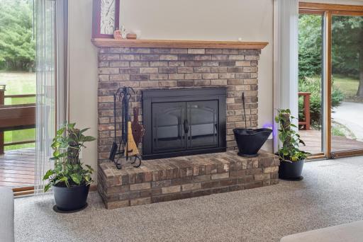 A classic brick fireplace adds warmth and character to the great room, perfect for cozy Minnesota evenings.