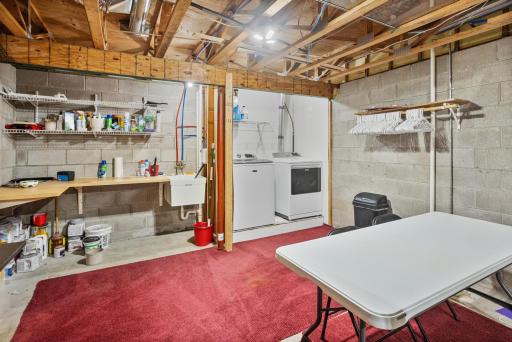 Dedicated laundry space with a utility sink, work surface and room for everyday household storage.