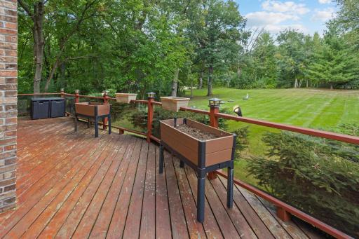 Expansive deck space overlooking the beautiful yard and mature trees.