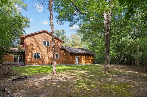A peaceful backyard surrounded by mature trees creates a wonderfully private setting.
