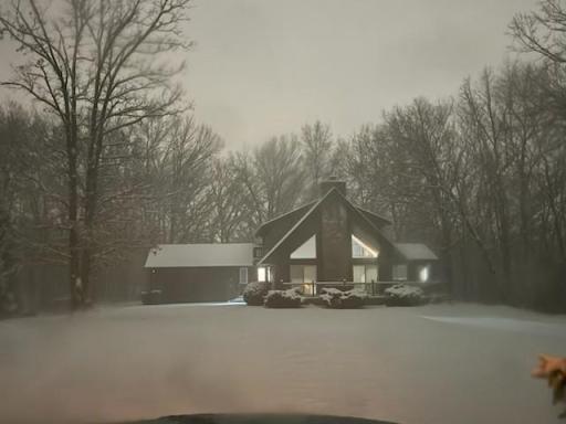 A peaceful winter retreat surrounded by snow-covered woods.