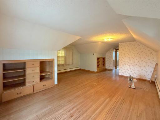 Spacious upper-level third bedroom features hardwood floors, built-in storage and plenty of room for furnishings.