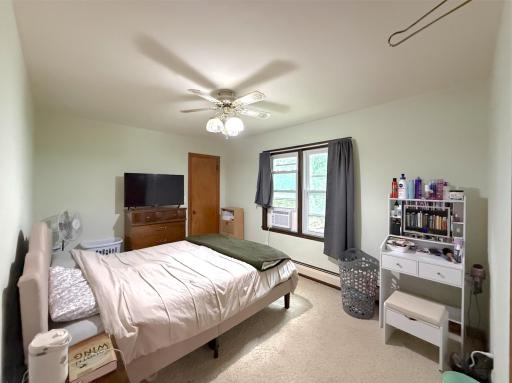 Main-level primary bedroom offers a spacious layout with plenty of room for furnishings and a large window bringing in natural light.
