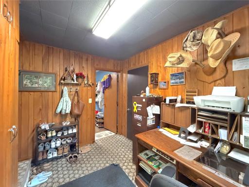 Wood-paneled mud room provides generous storage, workspace and easy access to the adjoining areas of the home including the garage.