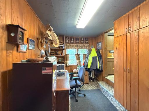 Convenient mud room offers a practical drop zone with plenty of built-in storage to stay organized and room for a home office setup.