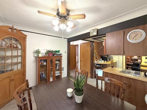 Bright dining room features updated flooring, natural light, ceiling fan and an open connection to the surrounding living spaces.