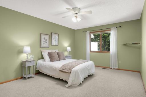 Spacious Ownerâs Bedroom with large window overlooking private backyard.