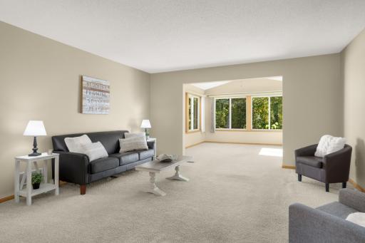Spacious Living Room opens directly into the Vaulted Sunroom.