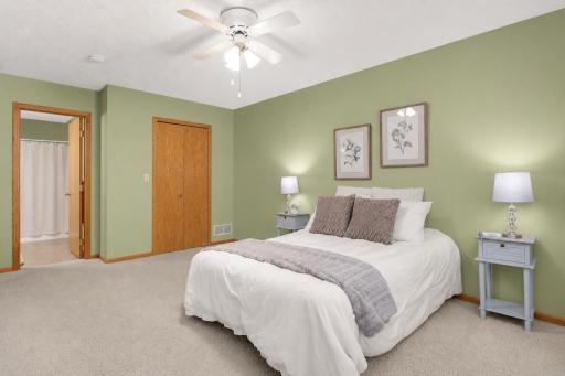 Another view of the large Ownerâs Bedroom with ceiling fan and private Bath nearby.