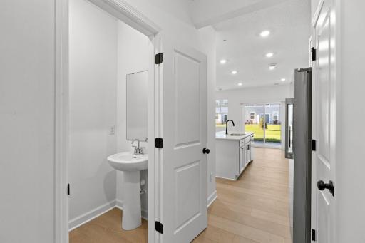 Situated directly off the kitchen, this powder room optimizes the first-floor main living area for residents and guests alike.