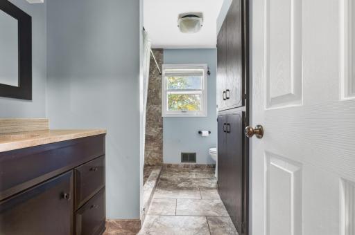 Updated 3/4 bath with ceramic tile on floor and shower walls, sink and light fixtures