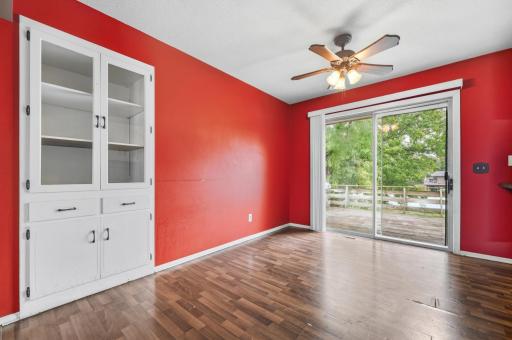 Bright and inviting living room featuring a built-in cabinet, and a large sliding glass door that fills the space with natural light and opens to the deck