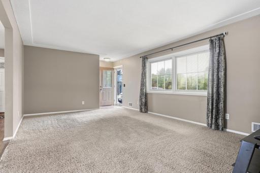 The living room is filled with an abundance of natural light that floods the home