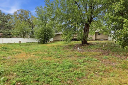 Large, maintenance-free fenced backyard with plenty of space to relax, play, garden, and entertain.