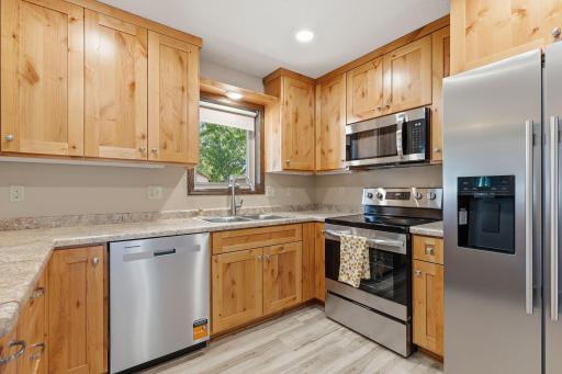 NEW Alder cabinetry and stainless steel appliances