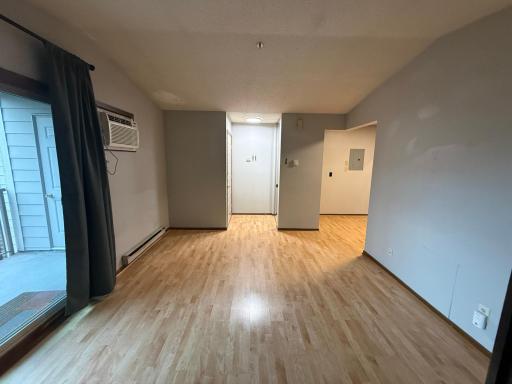 laminate floors. View of the entry from the bedroom doors. Kitchen is on the right