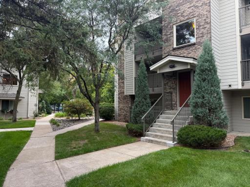 Lush, green entrance. Note siding has all been replaced