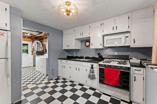 Lower level kitchenette leads to laundry, utilities and walkout.