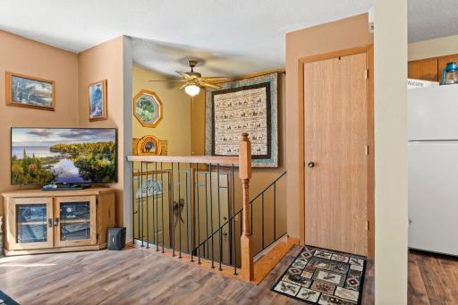 Open railing and storage closet at the top of the stairs. Great feeling to be able to see the door from this level and not being closed off.