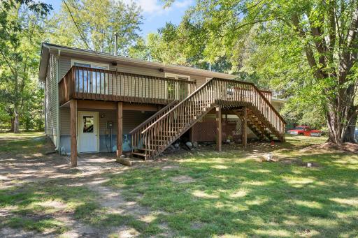 View of back of home with dual stairs for the deck.