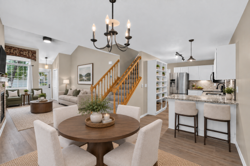 Open-concept living and dining area creates an easy, functional flow. Digitally Staged