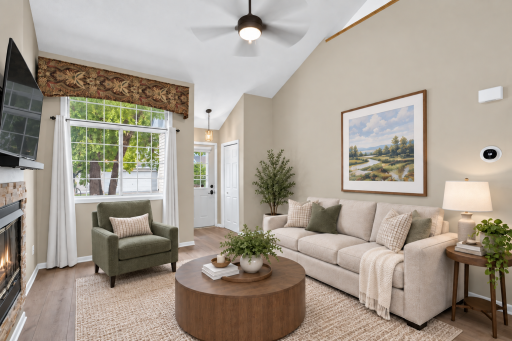 Spacious main-level living area with abundant natural light. Digitally Staged