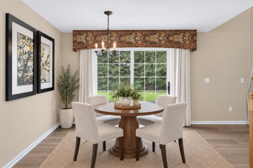 Dining space opens directly to the living room and kitchen. Digitally Staged