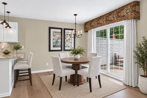 Dining space opens directly to the living room and kitchen. Digitally Staged