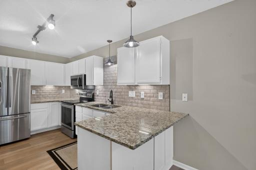 Bright, functional kitchen with breakfast bar and generous storage.