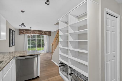 Custom California Closets shelving provides thoughtfully designed kitchen storage.