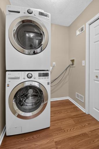 Dedicated in-unit laundry room provides convenient additional storage and workspace.