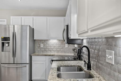 Well-designed kitchen offers ample cabinetry, counter space and convenient storage.